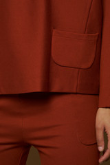 Cropped black girl inseam and pocket with a reddish outfit