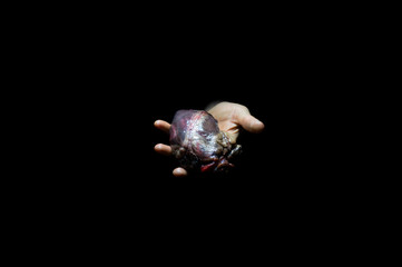 heart in hand on a black background