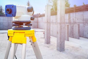Theodolite in close-up. Theodolite on the background of the Foundation of a new house. Monitoring...