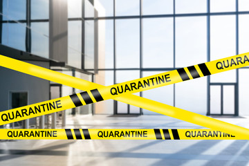 An empty lobby of the business center with restraining tapes and the words Quarantine. Offices are closed for coronavirus quarantine. Ban on conducting business due to Covid-19.