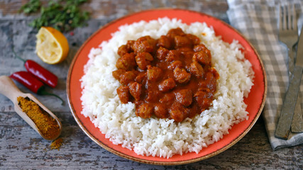 Selective focus. Plate of rice with vegan curry. Cooking at home. Curry Sauce. Vegan food.