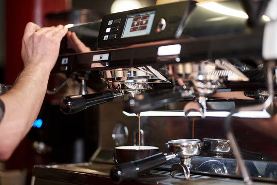 Espresso machine pouring coffees