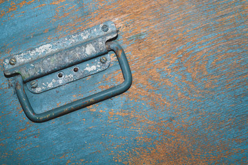 Shabby wood surface with metal handle. old wooden box with cracked paint