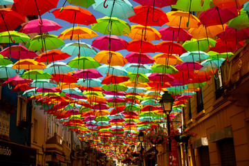 colorful umbrellas in the middle of the street