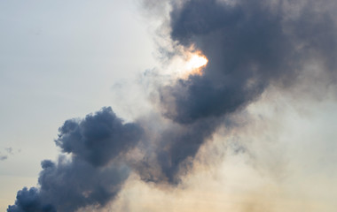 Fototapeta na wymiar black thick smoke against the sky