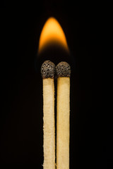 two matches on a black background