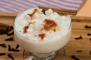bowl of hominy (Canjica) on a wooden tray,