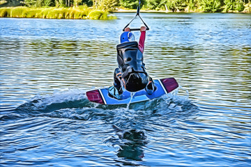 Naklejka premium Drawing of wakeboarding on the sea on summer day in life jacket. Soft focus. Action blur.