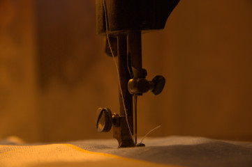 Vintage sewing machine in the rays of subdued light.