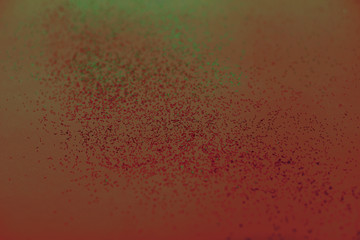 Red-green abstract background with small bokeh defocused lights.