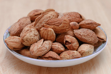 side view dish of almond nuts