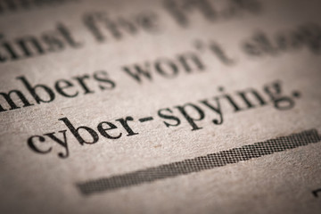 Close up shot of a cyber spying text written newspaper