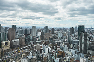 Obraz premium Osaka Skyline from High Viewpoint, Dense City Under Overcast Sky