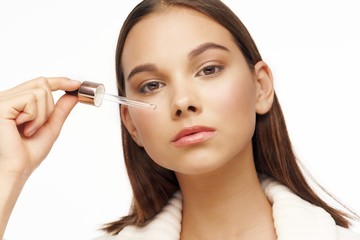 young woman applying mascara