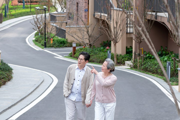 An Asian elderly couple walking