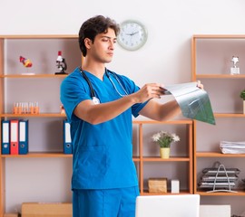 Young handsome doctor radiologyst working in clinic