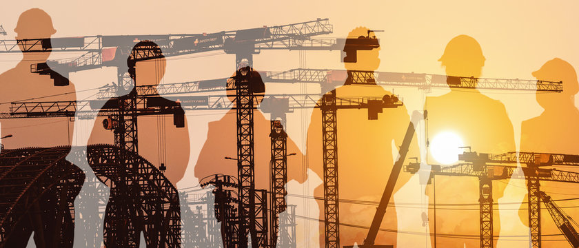 multiexposure construction industrial background of shadow of construction project engineers and workers overlay with silhouette construction project site background
