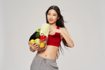 young woman holding vegetables