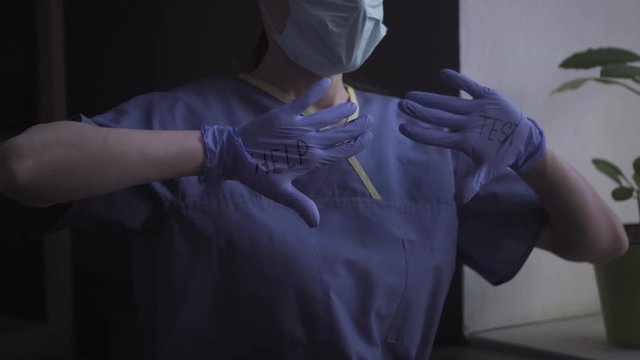 Doctor showing hands with HELP tes t sign on them