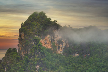 twilight skyline with cliff hill and fog morning in chumporn of thailand