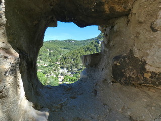 Window on the verdant hills of Fontaine de Vaucluse in Provence from the ruined castle of the village