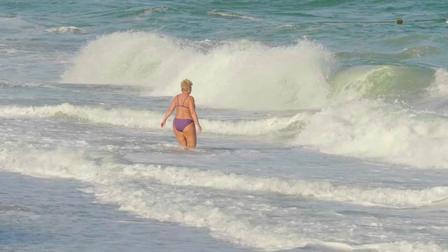 Grandma enjoys bathing in the sea.