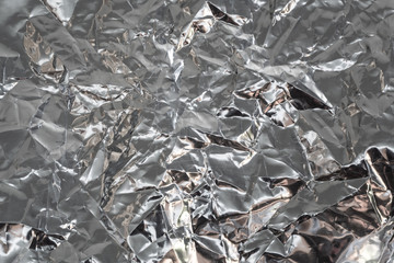 Abstract crumpled reflective silver material background 