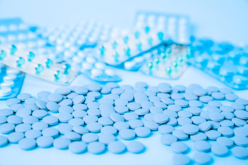 A scattering of medical pills. Medication timing, concept of medicine, magic placebo, homeopathy.