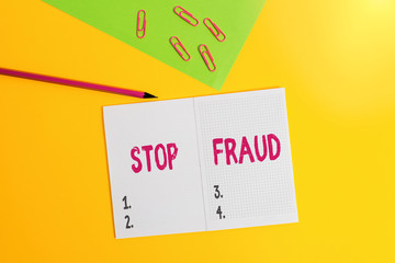 Text sign showing Stop Fraud. Business photo showcasing campaign advices showing to watch out thier money transactions Blank paper sheet pencil clips smartphone two notepads colored background