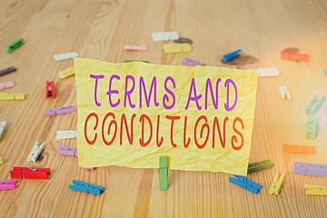 Writing note showing Terms And Conditions. Business concept for rules that apply to fulfilling a...