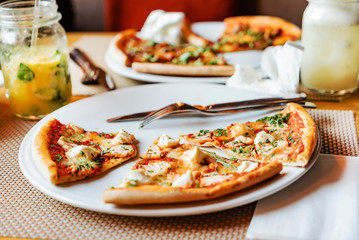 friends eating pizza in a indoor cafe