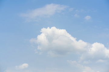 Naklejka na ściany i meble Blue sky with white soft clouds. Simple outdoor sky background.