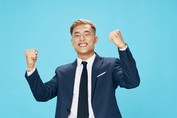 happy businessman with arms raised