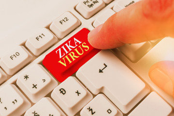 Conceptual hand writing showing Zika Virus. Concept meaning caused by a virus transmitted primarily...