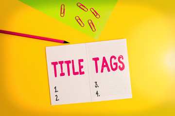 Text sign showing Title Tags. Business photo showcasing the HTML element that specifies the title of a web page Blank paper sheet pencil clips smartphone two notepads colored background