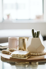 Modern Coffee Table with Coffe Mug, Gold Candle, and Cactus
