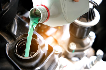 Refueling and pouring oil quality into the engine motor car Transmission and Maintenance Gear .Energy fuel concept.