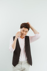 Handsome asian man using mobile over white background.