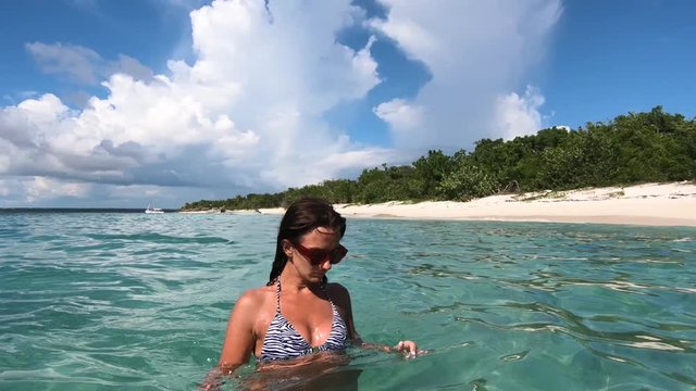 Slow motion - Young beautiful female feeling fun free and happy on tropical beach in ocean paradise. Travel sea background Atlantic ocean.