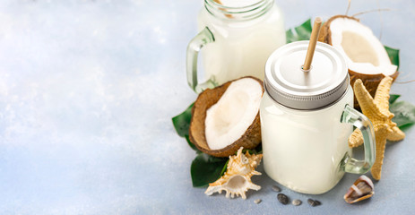 Coconut water drink or milk in glass jars Healthy summer tropical beverage