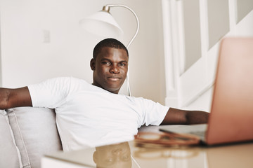 A man of African appearance in front of a laptop
