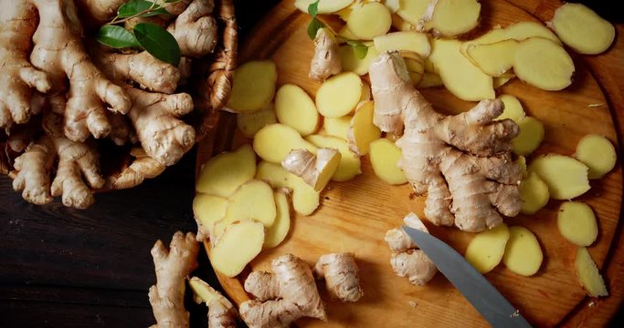 Slices of fresh ginger on the cutting Board slowly rotate.