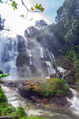 Spray of water and wet rocks on Vachiratharn waterfall