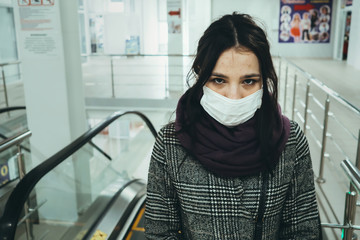 woman wearing a medical mask to protect against the COVID-19 coronavirus epidemic in a public place