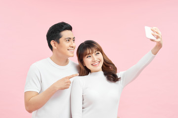 Close up view photo portrait of two cute sweet lovely excited joyful attractive delightful people making taking selfie isolated background