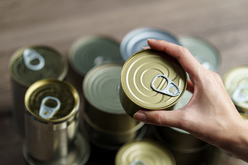 Woman hand with group of Aluminium canned food.