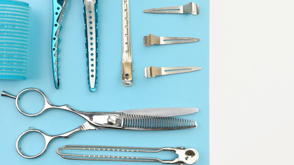 Set of professional hairdresser tools on white and blue background