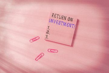 Conceptual hand writing showing Return On Investment. Concept meaning performance measure used evaluate efficiency of investment Colored sticky note clips gathered trendy cool pastel background