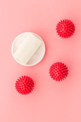 Coronavirus and soap on pink background top-down copy space