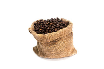Roasted coffee beans falling in a burlap sack. Sackcloth bag with coffee beans, isolated on white background